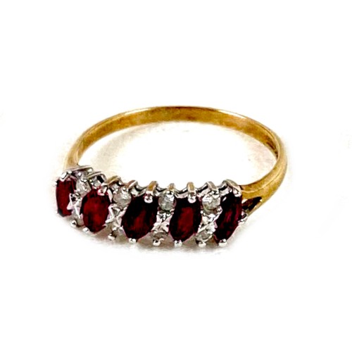 165 - A 9ct yellow gold, ruby and diamond ring, set with five oval cut rubies, each 4.0 by 2.5mm, interspe... 