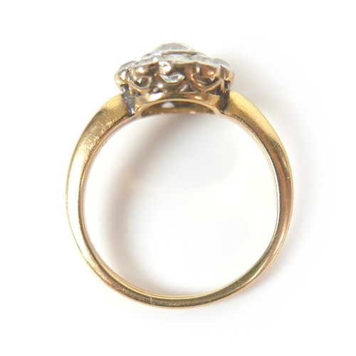 201 - An 18ct gold diamond daisy set ring, central stone approximately 5mm in diameter, surrounded by ten ... 