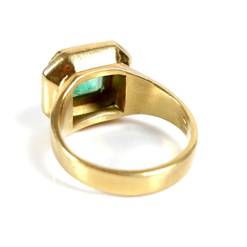 205 - An 18ct gold and Colombian emerald ring, the octagonal cut stone 8 by 8mm, within an octagonal setti... 