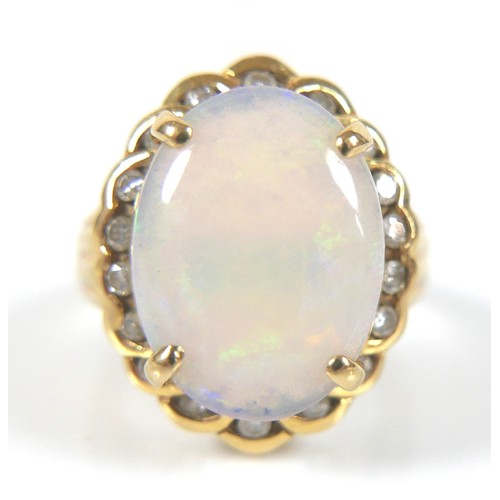 191 - An 18ct gold, opal and diamond dress ring, the central oval opal 1.6 by 1.2cm, surrounded by 18 bril... 