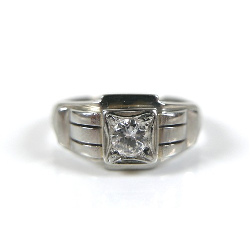 189 - A diamond solitaire ring, Art Deco style, the central brilliant cut stone 4 by 2.5mm, 0.25ct, on an ... 