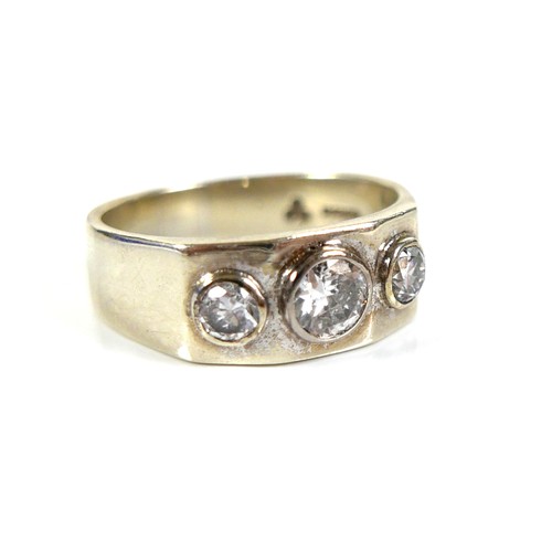 195 - A 9ct white gold and diamond three stone ring, the graduated stones brilliant cut and in rubover set... 