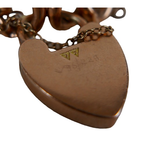 154 - A 9ct rose gold curb link charm bracelet with heart shaped padlock clasp, 20g.