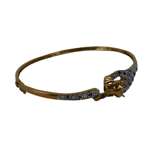 157 - A 9ct gold diamond and sapphire hinged bangle modelled as a leopard, internal diameter measured 6.3 ... 