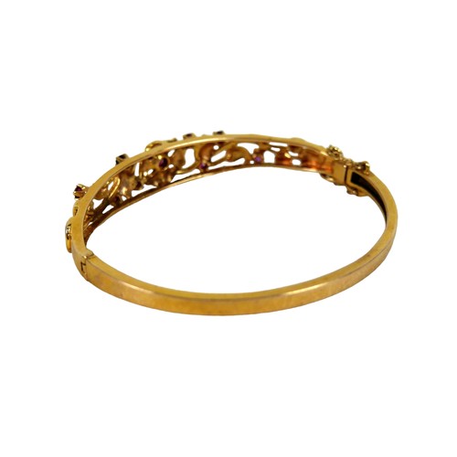 158 - A 9ct gold floral bangle, a yellow gold oval form hinged bangle, open work textured detail set with ... 