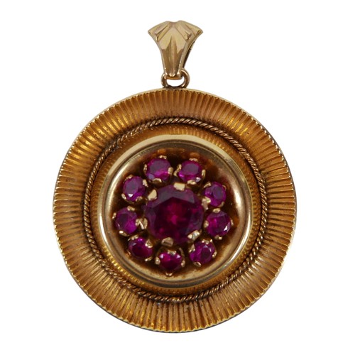 160 - An 18ct gold and ruby pendant, a circular setting with large round cut ruby, 6.8mm, surrounded by ni... 