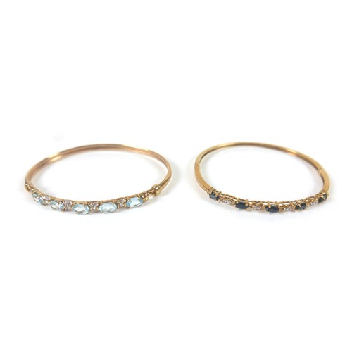 148 - Two gold and gem stone bangles, including a 9ct gold blue topaz bangle, the topaz interspersed with ... 