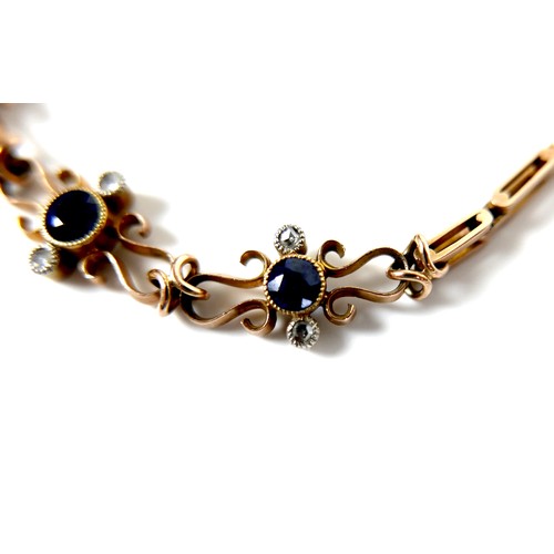 186 - A 9ct yellow gold and sapphire bracelet, with three scrolling panels, each set with a circular facet... 