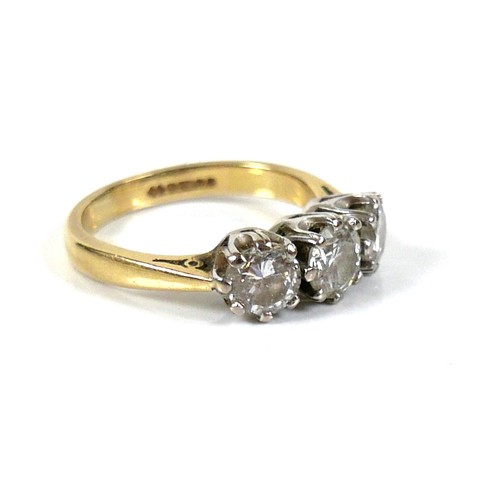 207 - An 18ct gold three stone diamond ring, round brilliant cut, central stone 0.6ct, 5.2 by 3.5, flanked... 