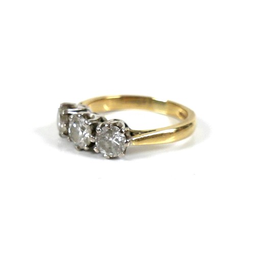 207 - An 18ct gold three stone diamond ring, round brilliant cut, central stone 0.6ct, 5.2 by 3.5, flanked... 