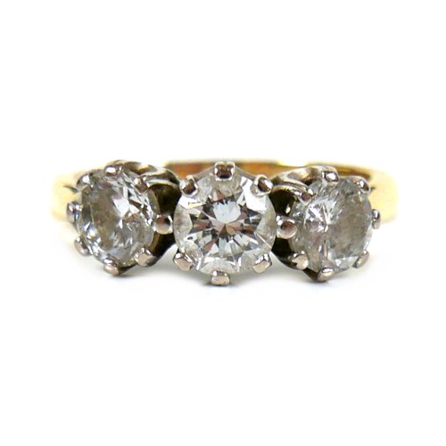 207 - An 18ct gold three stone diamond ring, round brilliant cut, central stone 0.6ct, 5.2 by 3.5, flanked... 