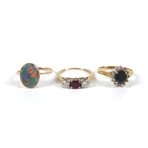 187 - A group of three gold rings, comprising a 14ct and 18ct gold diamond and ruby three stone ring, each... 