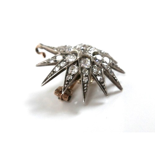 200 - A Victorian diamond set starburst brooch, the central diamond of approximately 0.22ct, 3.2mm, surrou... 