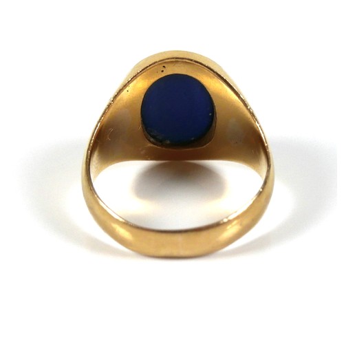 185 - An unmarked yellow gold ring, set with a cabochon blue stone, 13 by 12 by 5mm, on a plain graduating... 