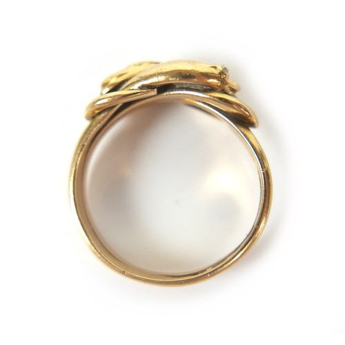 182 - An 18ct gold crossover serpent headed ring, size Q/R, 8.4g.