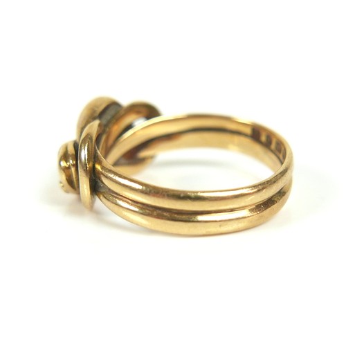 182 - An 18ct gold crossover serpent headed ring, size Q/R, 8.4g.