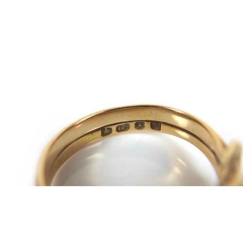 182 - An 18ct gold crossover serpent headed ring, size Q/R, 8.4g.