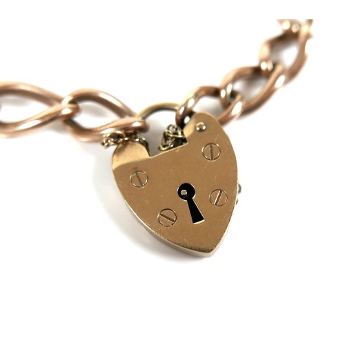 193 - A 9ct yellow gold curb link bracelet, with heart shaped padlock clasp and safety chain, 0.9 by 16cm ... 