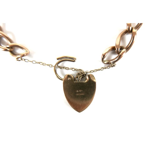 193 - A 9ct yellow gold curb link bracelet, with heart shaped padlock clasp and safety chain, 0.9 by 16cm ... 