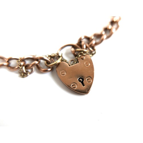 179 - A 9ct rose gold curb link bracelet, with heart shaped padlock clasp and safety chain, 0.6 by 20cm lo... 