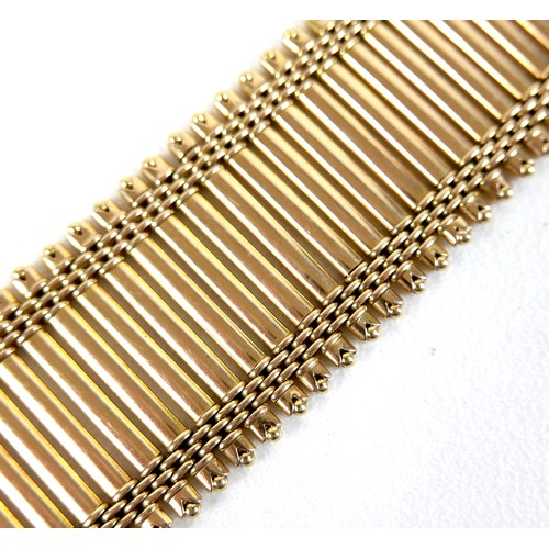 213 - An 18ct yellow gold bracelet, formed of forty-three parallel bars joined by bands of rounded brick l... 