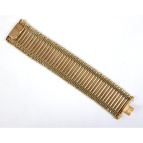 213 - An 18ct yellow gold bracelet, formed of forty-three parallel bars joined by bands of rounded brick l... 