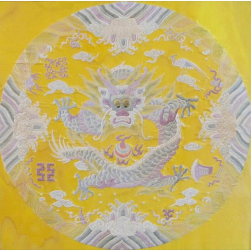 A Chinese yellow ground textile panel, late Qing dynasty, depicting a five clawed dragon chasing the flaming pearl within a circlet surround, possibly from a jifu, 54 by 54cm, mounted and framed, 93 by 93cm.
