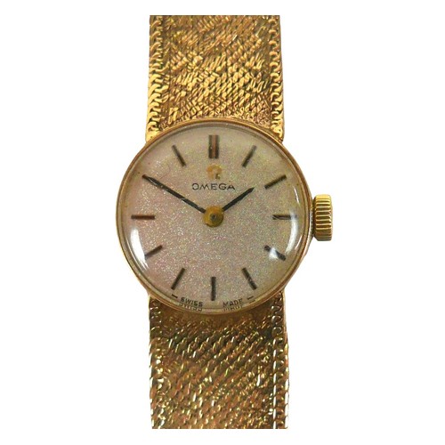 66 - A lady’s Omega 9ct gold wristwatch, gold case and bracelet, silvered dial and golden baton hour mark... 