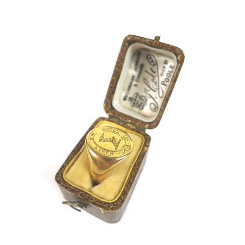 70 - A yellow metal armorial signet ring, no hallmarks, size K, 7.8g, with original box.