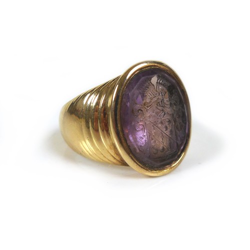 72 - An amethyst intaglio inset within a 9ct gold signet ring, unmarked but tests as 9ct, with armorial e... 