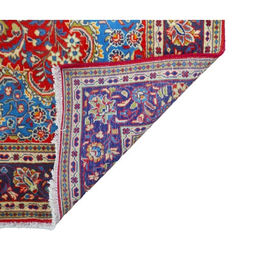 376 - A Kashan rug, with red and blue floral decoration, 210 by 135cm.