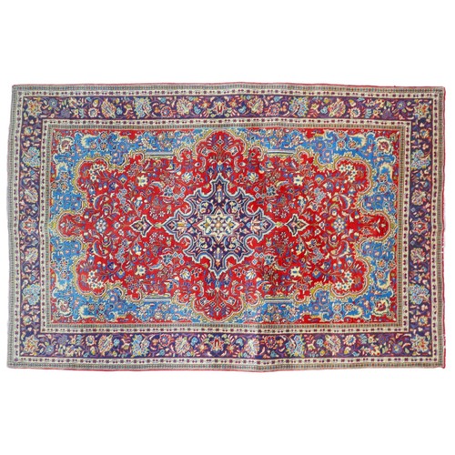 376 - A Kashan rug, with red and blue floral decoration, 210 by 135cm.