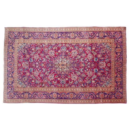 369 - A Kashan rug, with red ground, light and dark blue, cream and red foliate and floral decoration, 215... 