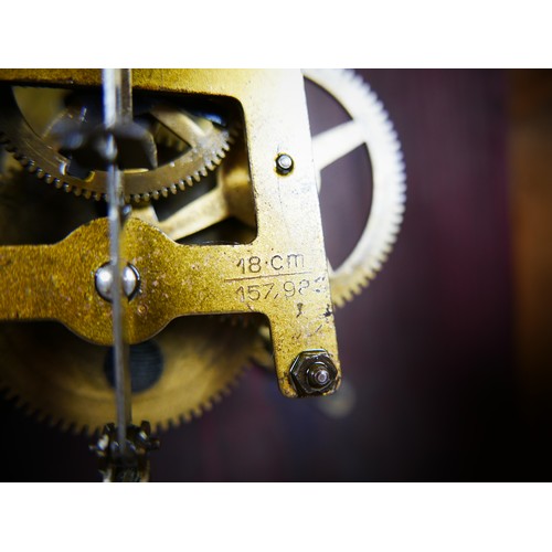 119 - A mahogany Kienzle dial clock, 41 by 14cm, dial 29cm, with pendulum.