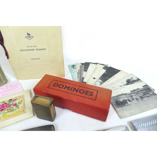 102 - A mixed group of collectables, including military memorabilia and badges, postcards, British coins a... 