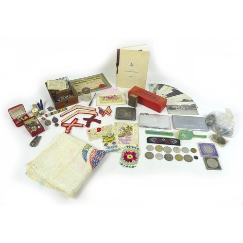 102 - A mixed group of collectables, including military memorabilia and badges, postcards, British coins a... 