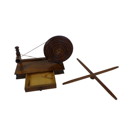 103 - A tabletop spinning/winding wheel, likely 19th century, 44 by 60 by 30cm high, together with a brass... 