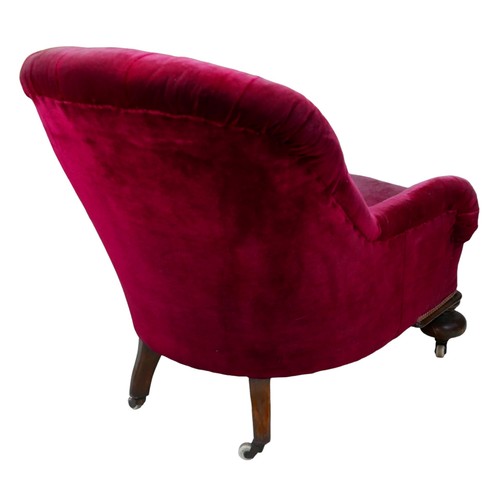 398 - A Victorian tub armchair, red velvet buttoned upholstery, cup feet castors, 91 by 73 by 83.5cm high.