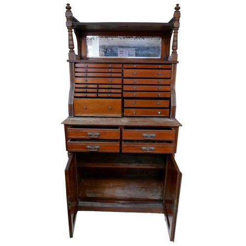 415 - An Aesthetic movement mahogany dentist's / collector's cabinet, with a mirror and eighteen draws to ... 