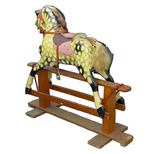 377 - An Edwardian rocking horse, painted decoration and red leather saddle, pine base, 136.5 by 47 by 117... 