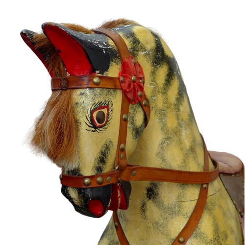 377 - An Edwardian rocking horse, painted decoration and red leather saddle, pine base, 136.5 by 47 by 117... 