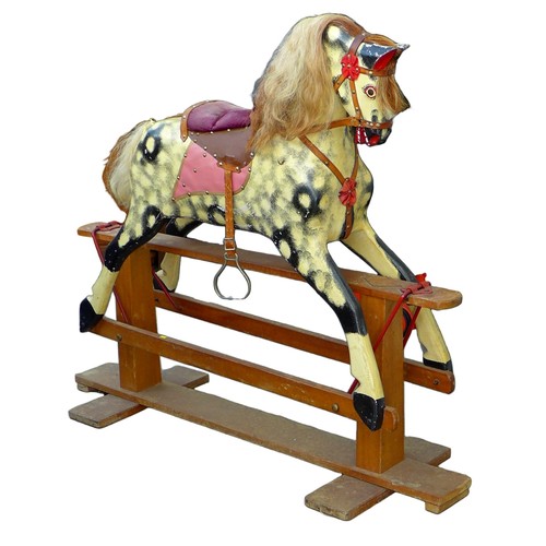 377 - An Edwardian rocking horse, painted decoration and red leather saddle, pine base, 136.5 by 47 by 117... 