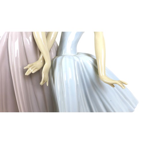 64 - A large Lladro figurine 'Merry Ballet', modelled as two ballerinas, raised on a circular wooden plin... 