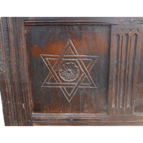 405 - A 16th or 17th century oak chest, the three panel front carved with six pointed stars, a/f replaceme... 