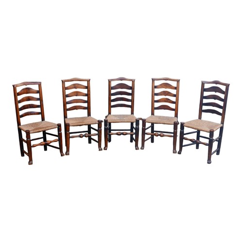 390 - A set of five 18th century oak country ladderback chairs, with rush seats. (5)