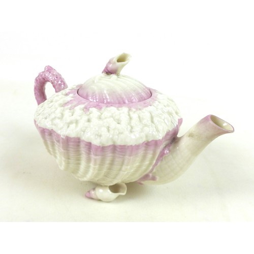 59 - A Belleek Echinus teapot with pink coral detail, decorated with gilt highlights and hand painted 'CM... 