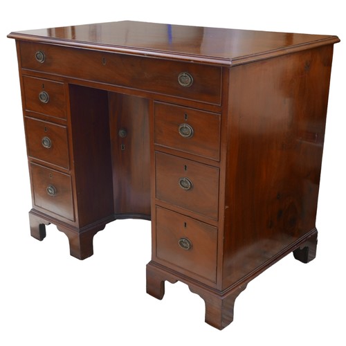 410 - A George III mahogany kneehole desk, with seven drawers each with ring handles, cupboard to kneehole... 