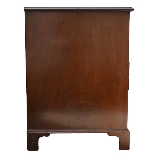 410 - A George III mahogany kneehole desk, with seven drawers each with ring handles, cupboard to kneehole... 