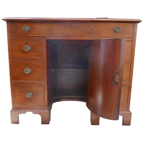 410 - A George III mahogany kneehole desk, with seven drawers each with ring handles, cupboard to kneehole... 