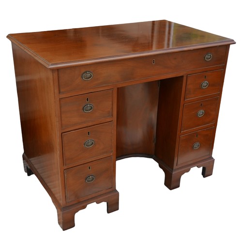 410 - A George III mahogany kneehole desk, with seven drawers each with ring handles, cupboard to kneehole... 